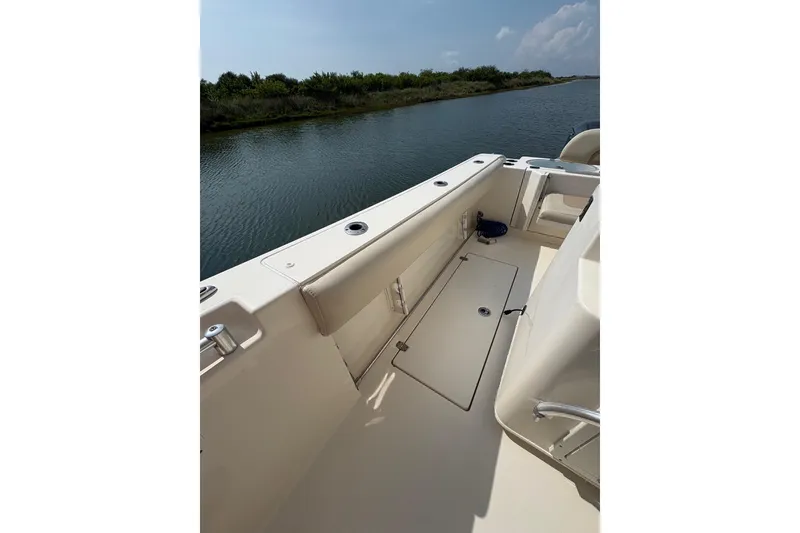 Slide: The Image of 2016 Cobia 296 Center Console boat interior, featuring spacious deck and water view. - 22