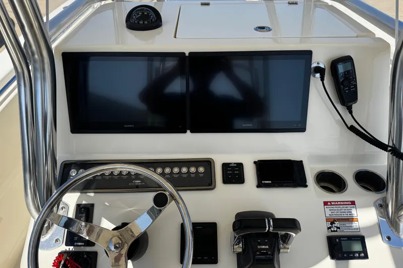 Slide: The Image of 2016 Cobia 296 Center Console dashboard with dual Garmin screens and Yamaha controls. - 7