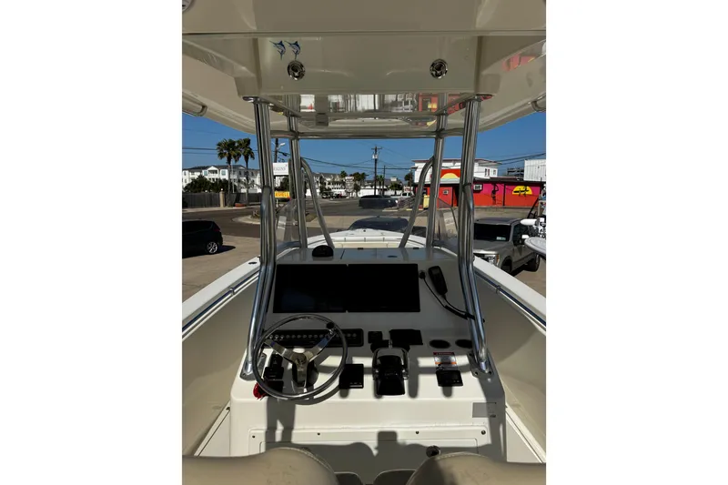 Slide: The Image of 2016 Cobia 296 Center Console boat helm with steering wheel and controls. - 8