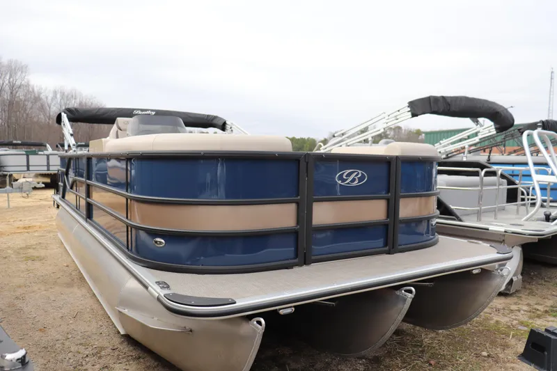 The Image of 2026 Bentley Pontoons Legacy 223 Fish N Cruise, blue and beige pontoon boat, docked outdoors. - 0