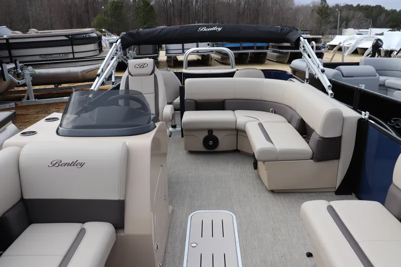 Slide: The Image of 2026 Bentley Pontoons Legacy 223 Fish N Cruise interior with beige seating and helm. - 1