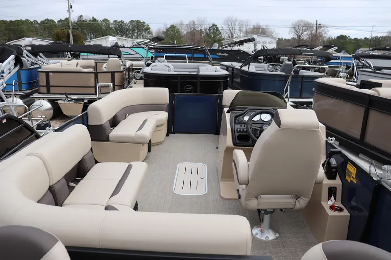 Slide: The Image of 2026 Bentley Pontoons Legacy 223 Fish N Cruise interior with beige seating and control console. - 11