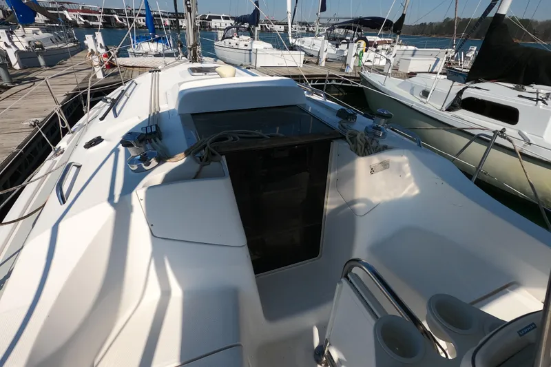 Slide: The Image of 2006 Hunter 33 sailboat cockpit at marina, showcasing deck and rigging details. - 10