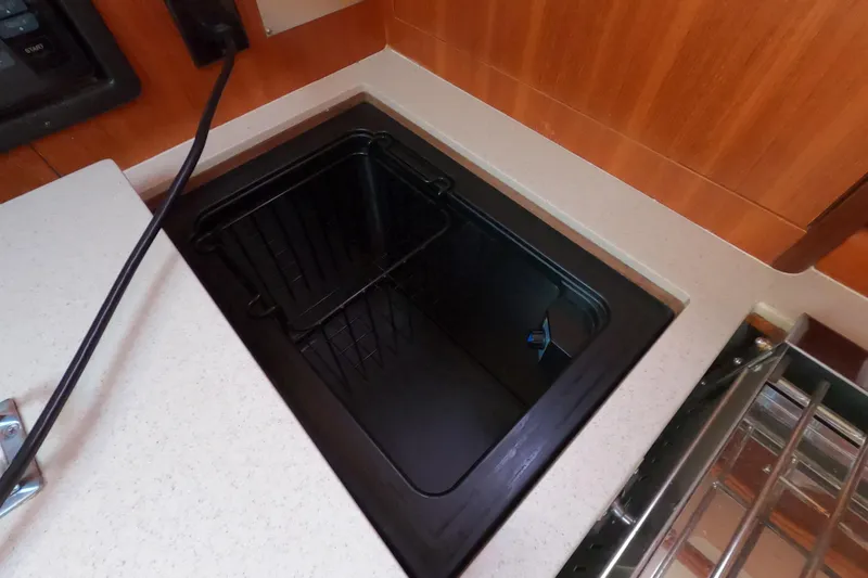 Slide: The Image of Black sink in 2006 Hunter 33 yacht kitchen with wooden cabinetry. - 17
