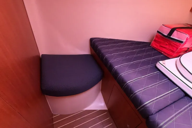 Slide: The Image of Interior of a 2006 Hunter 33 sailboat with cushioned seating and storage. - 23