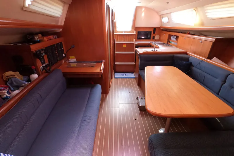Slide: The Image of Interior of 2006 Hunter 33 sailboat with wooden furnishings and blue seating. - 25