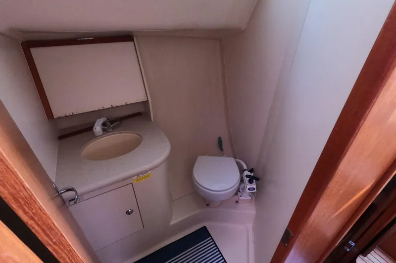 Slide: The Image of Compact bathroom in a 2006 Hunter 33 sailboat with sink and toilet. - 28