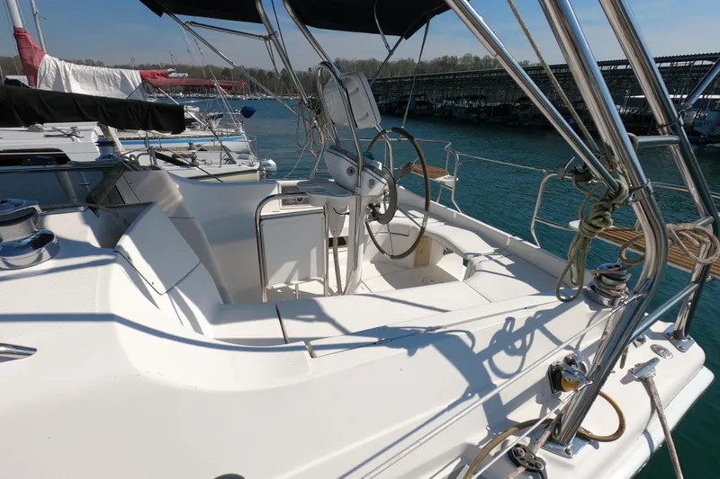 Slide: The Image of 2006 Hunter 33 sailboat cockpit with steering wheel, docked at marina. - 33