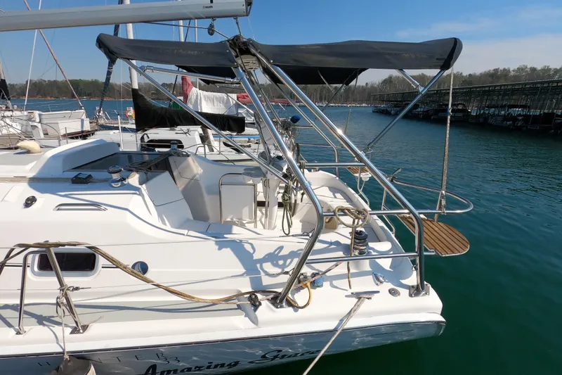 Slide: The Image of 2006 Hunter 33 sailboat docked at marina, featuring sleek design and spacious deck. - 5