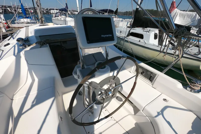 Slide: The Image of Cockpit of a 2006 Hunter 33 sailboat with steering wheel and navigation display. - 8