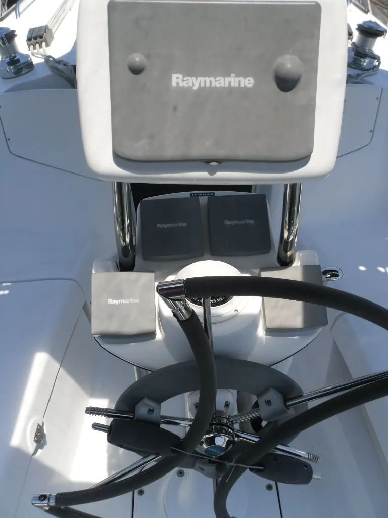 Slide: The Image of Cockpit of a 2006 Hunter 33 sailboat featuring Raymarine equipment. - 9