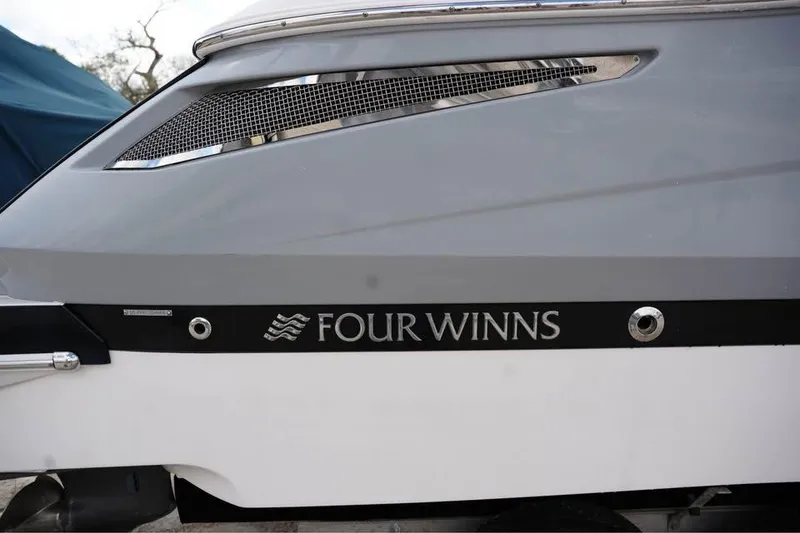 Slide: The Image of 2015 Four Winns H290 boat side view with logo and sleek design. - 12