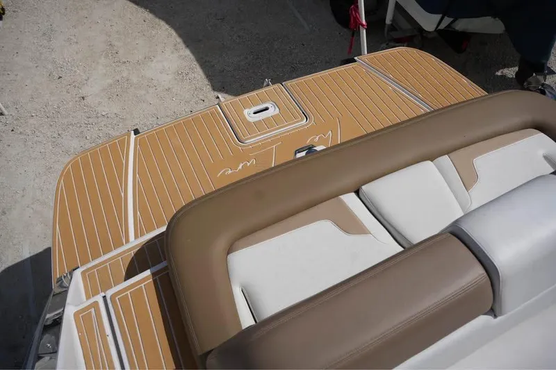 Slide: The Image of 2015 Four Winns H290 boat deck with tan and white seating. - 15