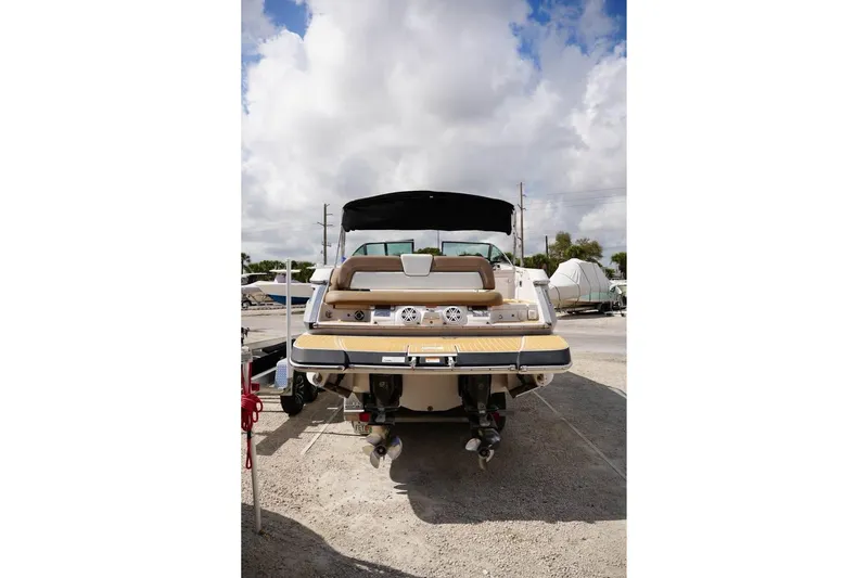 Slide: The Image of Rear view of 2015 Four Winns H290 boat with dual engines, parked outdoors. - 19