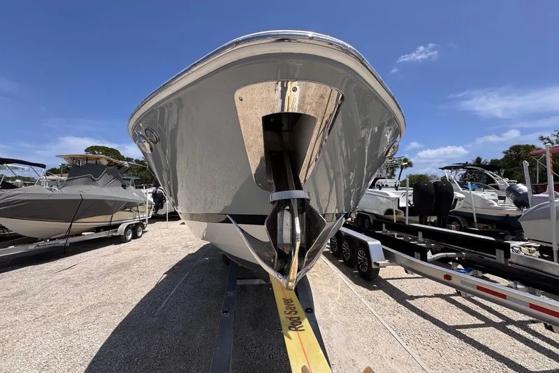 Slide: The Image of 2015 Four Winns H290 boat on trailer under clear blue sky. - 28
