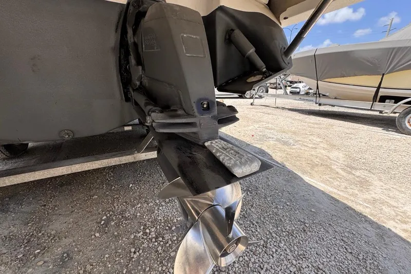 Slide: The Image of 2015 Four Winns H290 boat propeller and drive system on a gravel surface. - 34