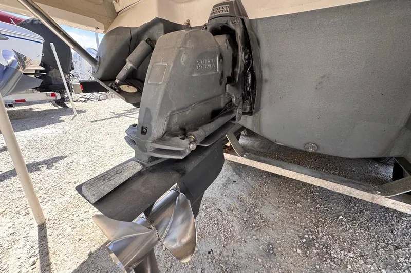 Slide: The Image of 2015 Four Winns H290 boat with Volvo Penta outdrive, parked on gravel. - 35