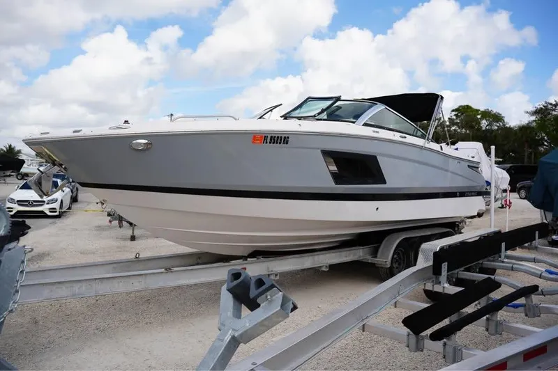 Slide: The Image of 2015 Four Winns H290 boat on trailer under cloudy sky. - 4