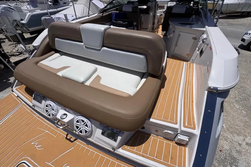 Slide: The Image of 2015 Four Winns H290 boat interior with cushioned seating and teak-style flooring. - 41