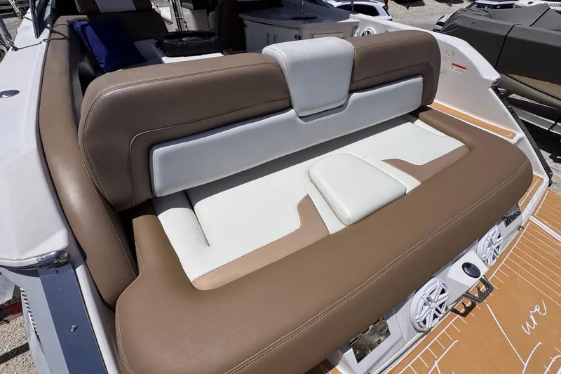 Slide: The Image of 2015 Four Winns H290 boat with tan and white cushioned seating. - 43