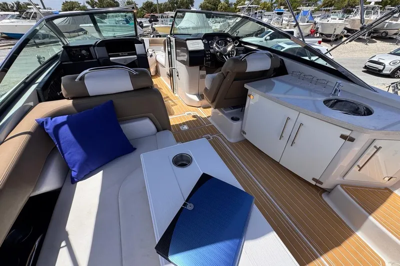 Slide: The Image of Interior of 2015 Four Winns H290 boat with seating, table, and kitchenette. - 47