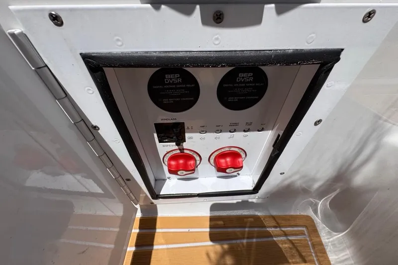 Slide: The Image of Electrical panel on 2015 Four Winns H290 boat with red switches and BEP DVSR. - 52