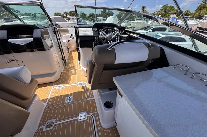 Slide: The Image of Interior view of a 2015 Four Winns H290 boat, featuring a sleek cockpit and seating area. - 56