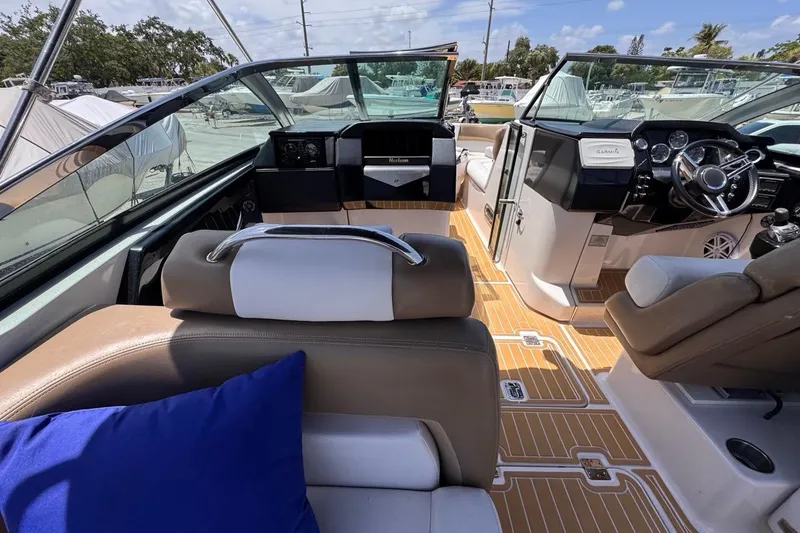 Slide: The Image of Interior of 2015 Four Winns H290 boat with modern dashboard and seating. - 57