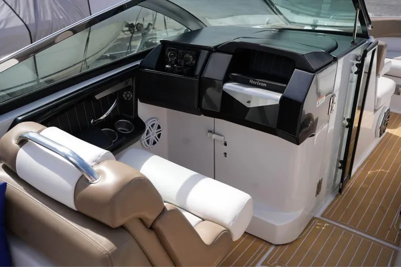 Slide: The Image of 2015 Four Winns H290 boat interior with helm, seating, and modern dashboard. - 6
