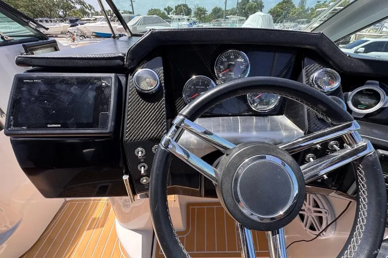 Slide: The Image of Dashboard of 2015 Four Winns H290 boat with steering wheel and Garmin GPS. - 60