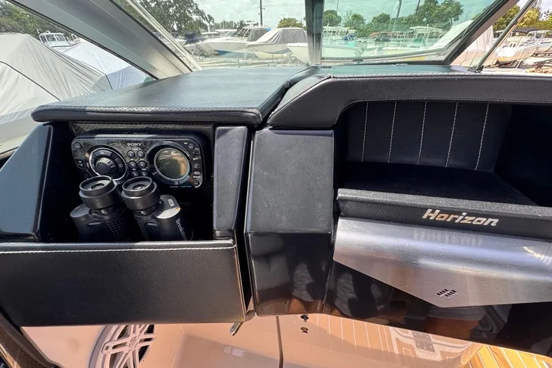 Slide: The Image of 2015 Four Winns H290 dashboard with Sony stereo and binoculars. - 61