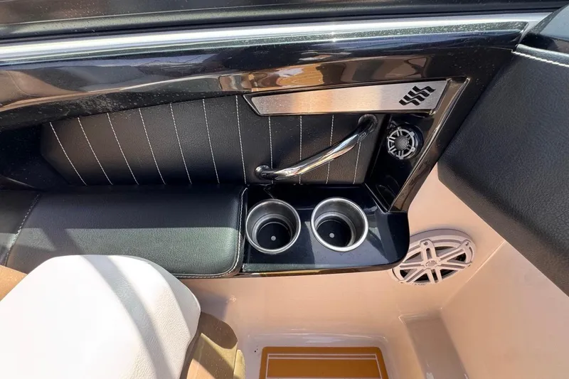 Slide: The Image of Interior of 2015 Four Winns H290 boat with cup holders and speaker. - 62