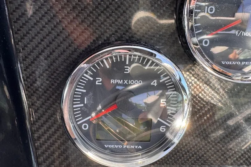 Slide: The Image of Close-up of 2015 Four Winns H290 boat tachometer, displaying RPM on carbon fiber dashboard. - 64