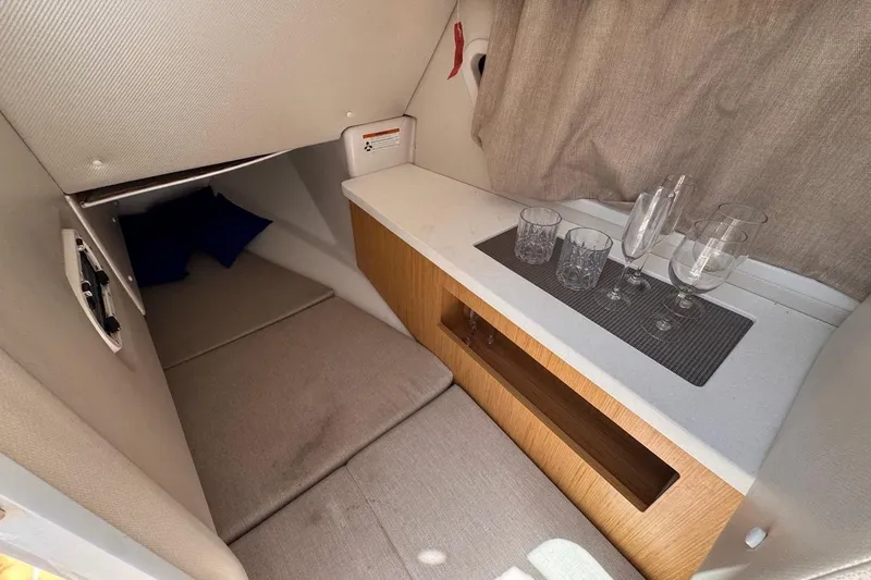 Slide: The Image of Interior cabin of 2015 Four Winns H290 boat with seating and glassware. - 69