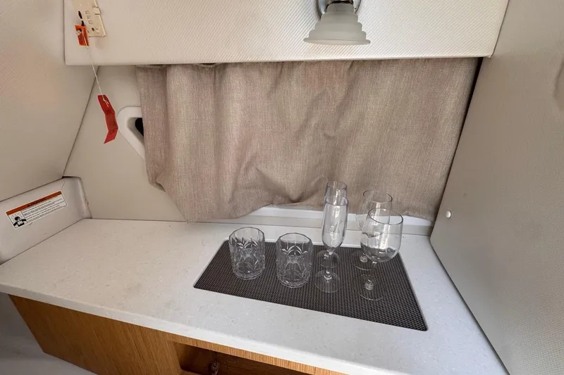 Slide: The Image of Interior of 2015 Four Winns H290 boat with glasses on counter. - 71