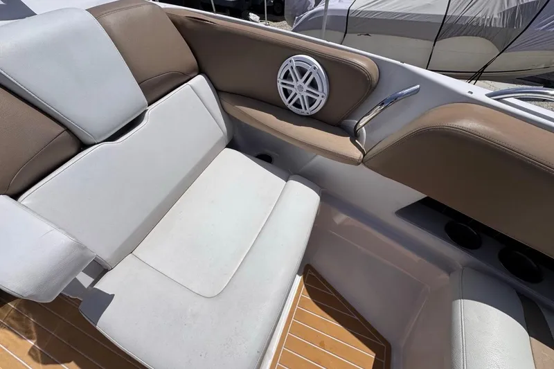 Slide: The Image of 2015 Four Winns H290 boat interior with cushioned seating and speaker detail. - 72
