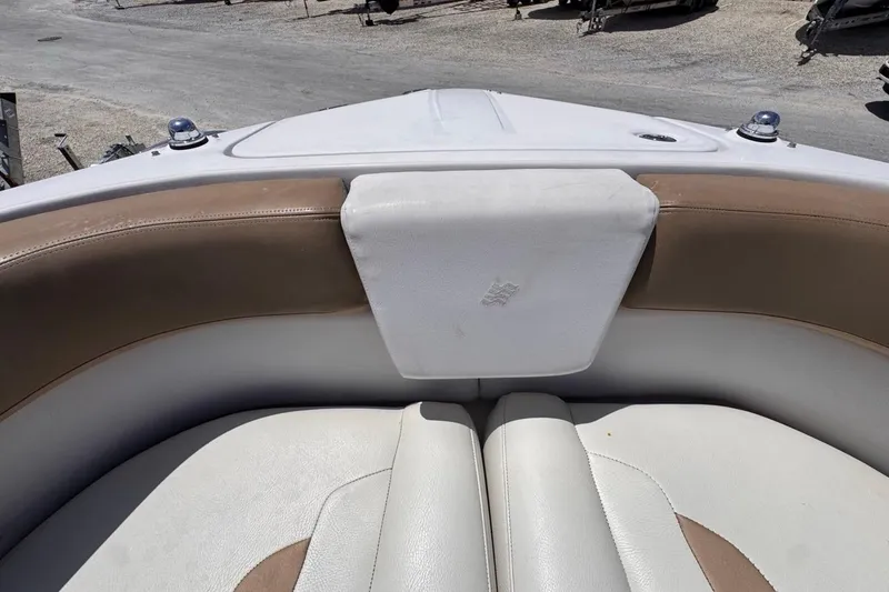 Slide: The Image of Bow seating area of a 2015 Four Winns H290 boat with tan and white upholstery. - 75