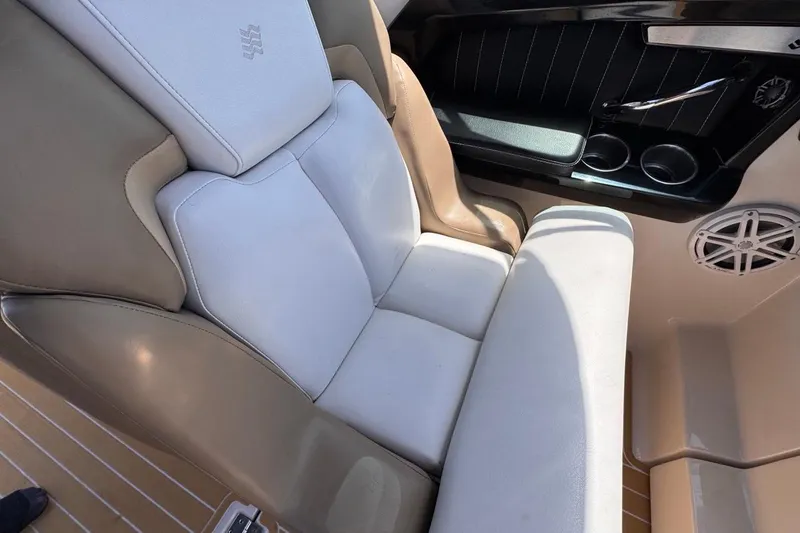 Slide: The Image of Luxurious seating on a 2015 Four Winns H290 boat, featuring cup holders and speaker. - 77