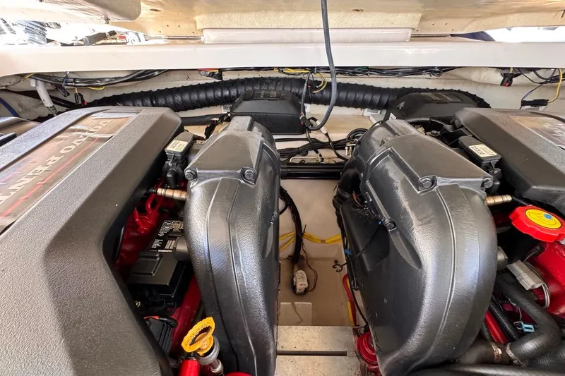 Slide: The Image of Engine compartment of a 2015 Four Winns H290 boat, showcasing dual engines. - 83