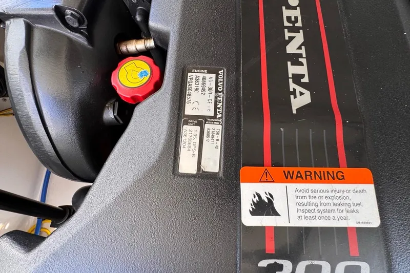 Slide: The Image of Volvo Penta engine in 2015 Four Winns H290 boat with warning label visible. - 85