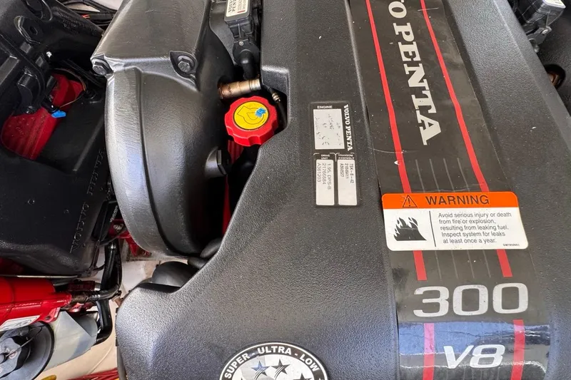 Slide: The Image of Volvo Penta V8 engine in 2015 Four Winns H290 boat, featuring warning label. - 86