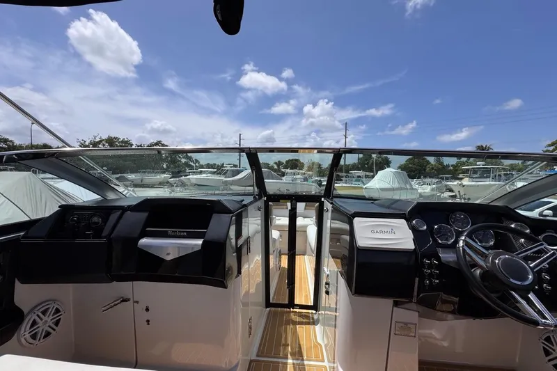 Slide: The Image of Interior view of 2015 Four Winns H290 boat cockpit with Garmin navigation system. - 91