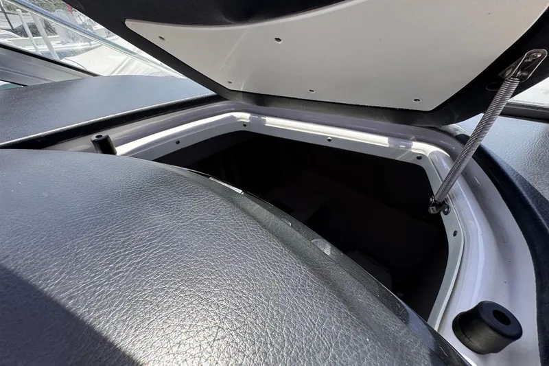 Slide: The Image of Open storage compartment on a 2015 Four Winns H290 boat. - 94