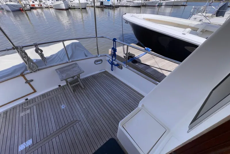 Slide: The Image of 1995 Island Gypsy Eurosedan 32 yacht deck with wooden flooring at marina. - 16