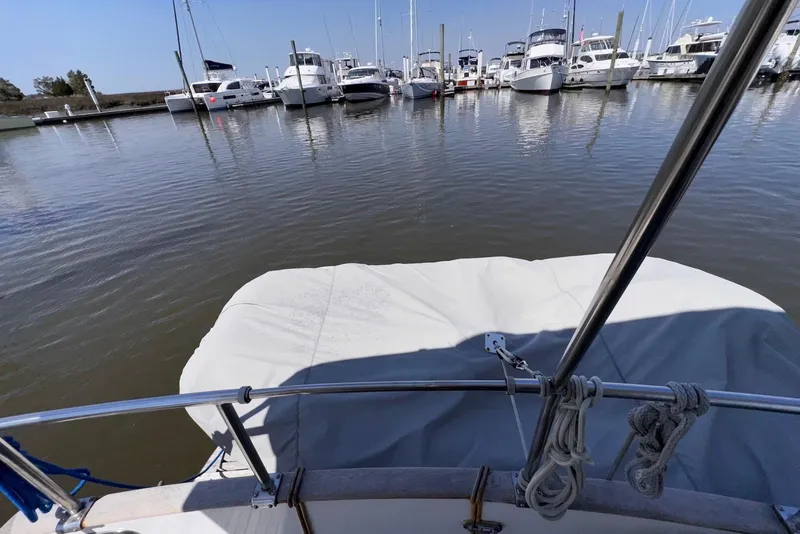 Slide: The Image of Island Gypsy Eurosedan 32, 1995 model, docked in a marina with other boats. - 17