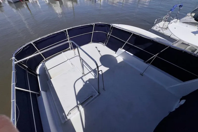 Slide: The Image of 1995 Island Gypsy Eurosedan 32 boat deck with railing and water view. - 18