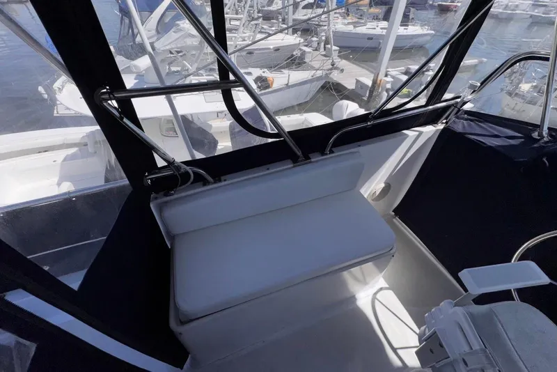 Slide: The Image of Interior view of a 1995 Island Gypsy Eurosedan 32 boat with seating and marina backdrop. - 20