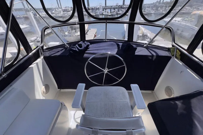 Slide: The Image of Helm of 1995 Island Gypsy Eurosedan 32 with marina view. - 21