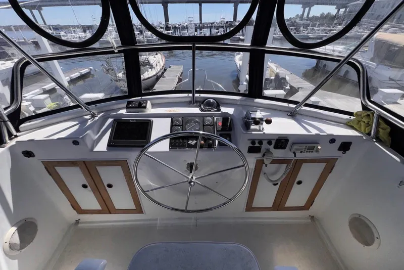 Slide: The Image of Helm of 1995 Island Gypsy Eurosedan 32, featuring steering wheel and navigation controls. - 23