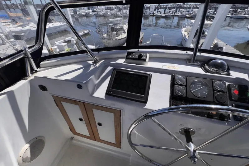 Slide: The Image of Helm of 1995 Island Gypsy Eurosedan 32 with steering wheel and navigation instruments. - 25